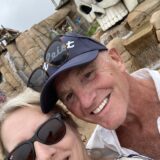 older folks sheila and tom smiling while at an amusement park